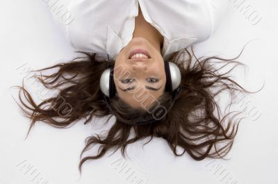 young female lying and enjoying music