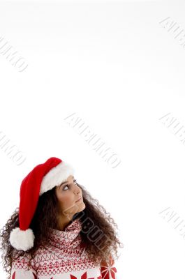 young female with christmas hat looking upward