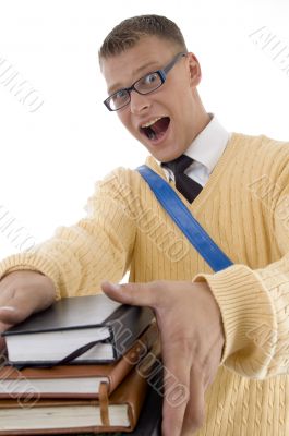 student wearing spectacles posing with his books