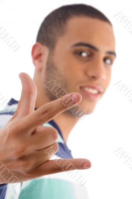 young guy showing rock hand gesture