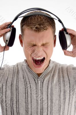 shouting young man holding the  headphone