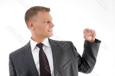 smiling businessman looking his fist