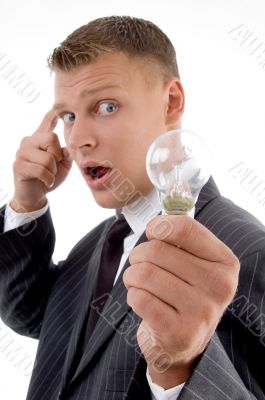 surprised young man holding electric bulb,
