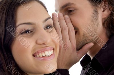 young man whispering to woman