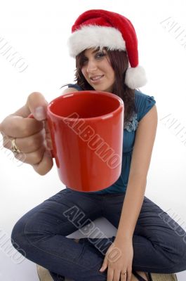 sitting woman showing coffee mug