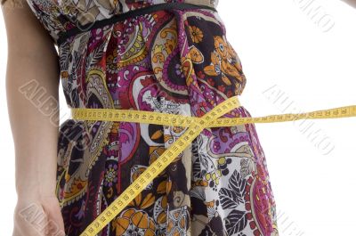 female measuring her waist