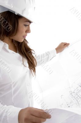 young female architect holding open blue prints