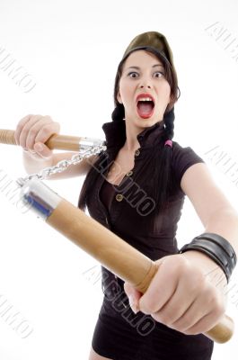 attractive young female holding nunchaku