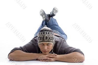 laying young man wearing winter cap