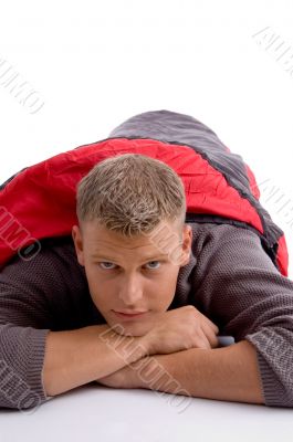 young man covered himself with red sleeping bag
