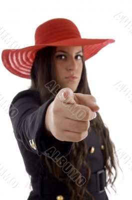 beautiful young female wearing hat pointing