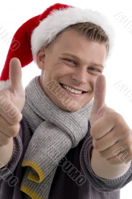 male with christmas hat showing thumb up