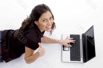 laying woman with laptop and looking upward