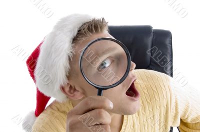man wearing santa hat and looking through lens
