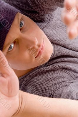 close up view of man`s face posing with open palm