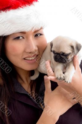 woman with cute puppy and christmas hat