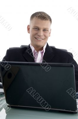 smiling young businessman with laptop