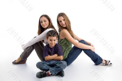 young kid sitting with teenagers