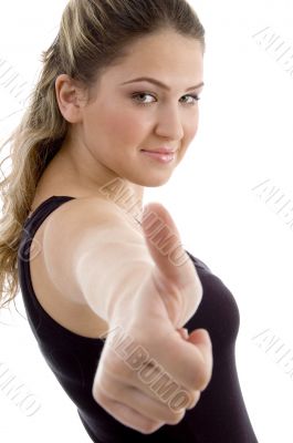 side view of smiling girl showing thumb up