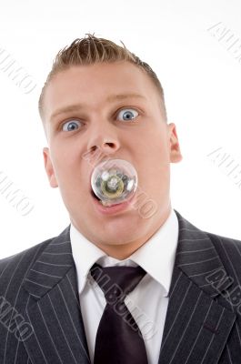 young caucasian holding electric bulb in his mouth