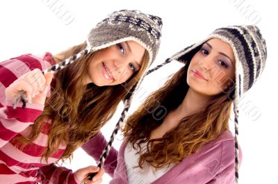 pretty girls wearing cap and looking at camera
