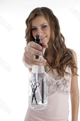 smiling young beautician showing spray bottle