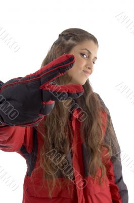 woman wearing jacket showing victory hand gesture