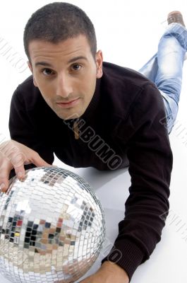 male model lying and posing with disco ball