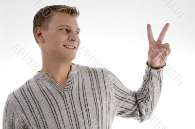 successful young man showing peace sign