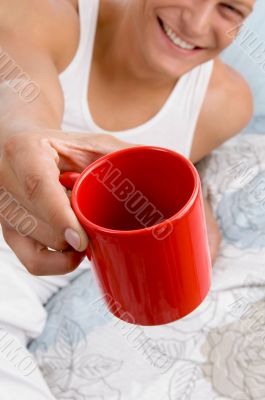 man showing coffee mug