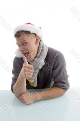 smiling man with christmas hat showing thumb up