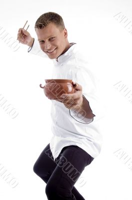 handsome chef posing with utensils