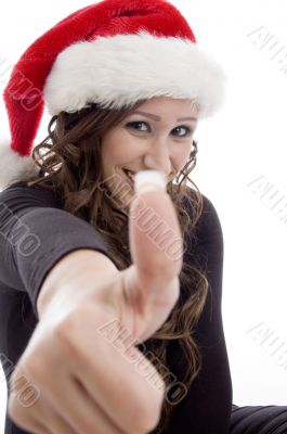 woman wearing christmas hat showing good