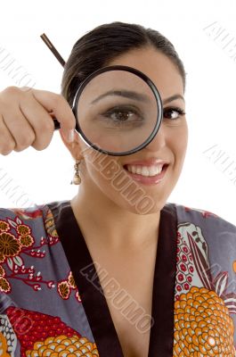 smiling female watching through magnifying lens