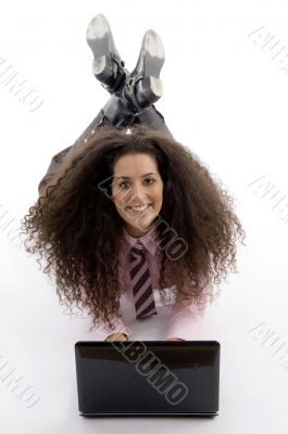 smart young businesswoman lying down with laptop