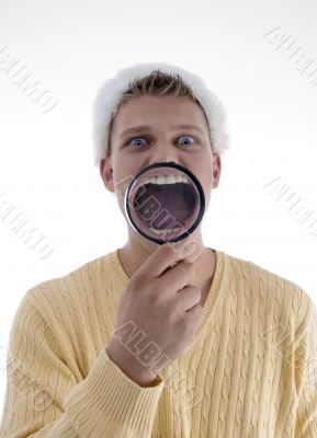 man weaing santa hat and showing lens