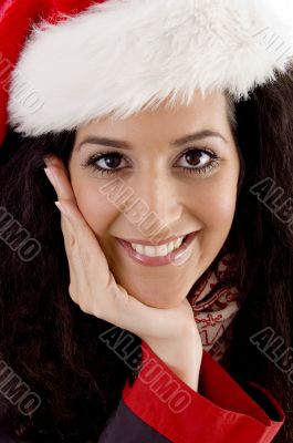 close up of smiling young woman with christmas hat