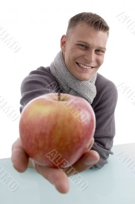 smiling male showing apple