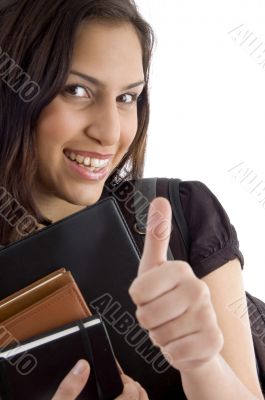 smiling college student showing thumbs up