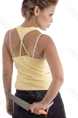 back pose of woman with knife