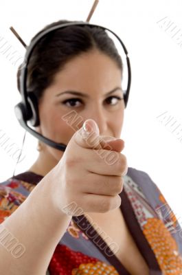 female wearing headphone pointing at camera