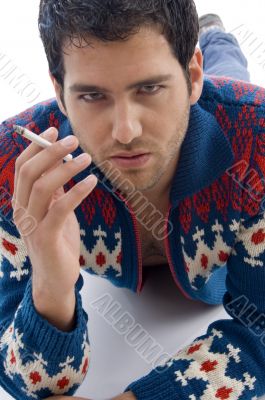 laying male holding cigarette