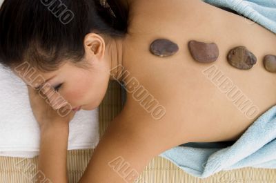  young female taking stone therapy