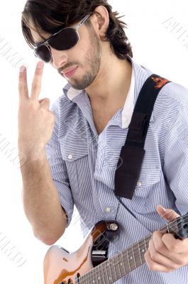 young guy holding guitar and gesturing