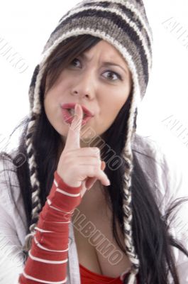 woman shushing and wearing winter cap