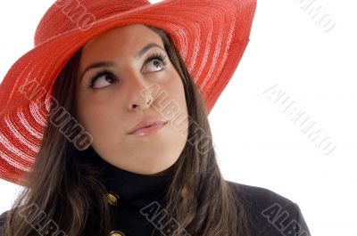 female wearing hat looking upward