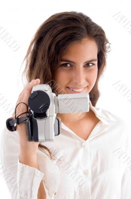 smiling woman holding video camera
