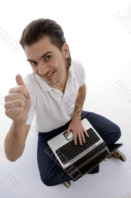 young man sitting with laptop