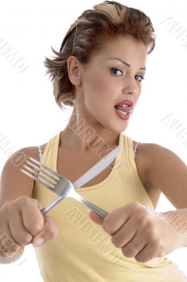young woman posing with fork and knife