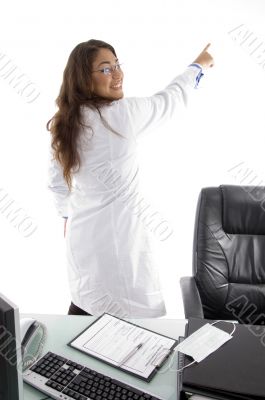 back pose of young doctor pointing back side
